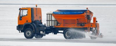 Streuwagen beim Winterdienst auf Straße