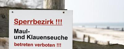 Schild mit der deutschen Aufschrift Maul und Klauenseuche, betreten verboten
