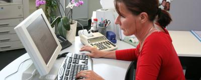 Gemeindemitarbeiterin arbeitet mit Computer