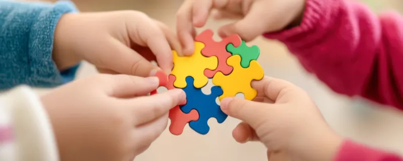 Kinder setzen ein Puzzle zusammen