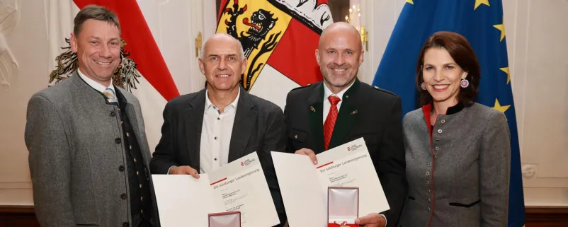 Landeshauptfrau Karoline Edtstadler bei der Verleihung an Johann Lanschützer und Johann Neumann, beide aus Mariapfarr. Links Bürgermeister Andreas Kaiser.