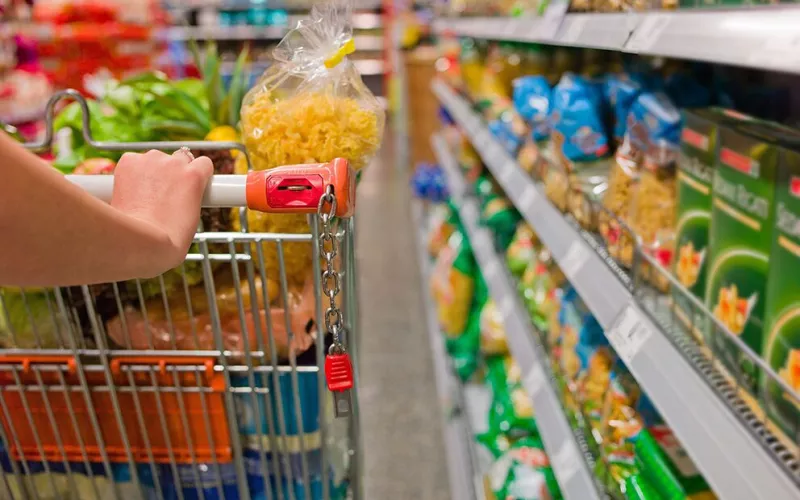 Frau mit Einkaufswagen im Supermarkt