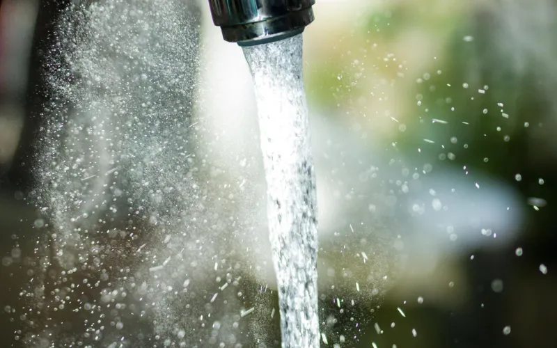 Wasser rinnt aus Hahn